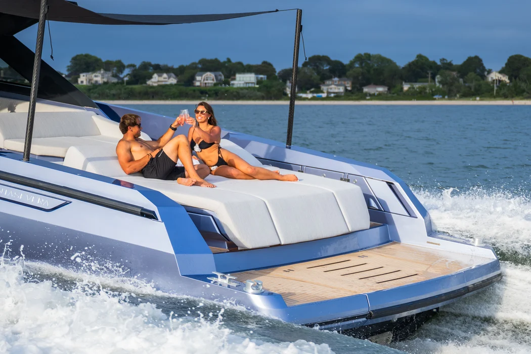 Couple celebrating anniversary on yacht sun deck with toast.