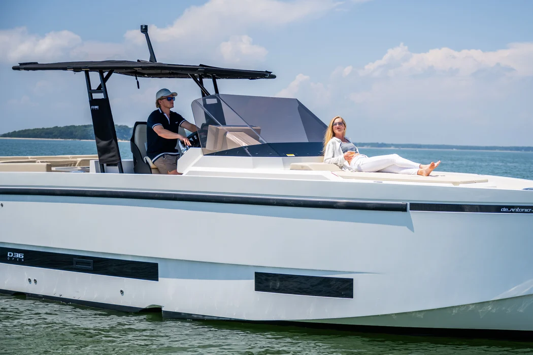 Two guests cruising Delray waters aboard sleek D36 yacht.