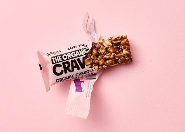 Organic granola bar with peanuts and cashews unwrapped.