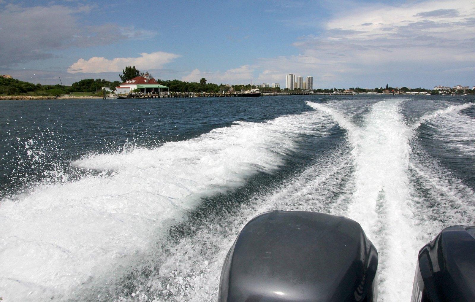 Boat wake across Lake Worth Lagoon with waterfront skyline