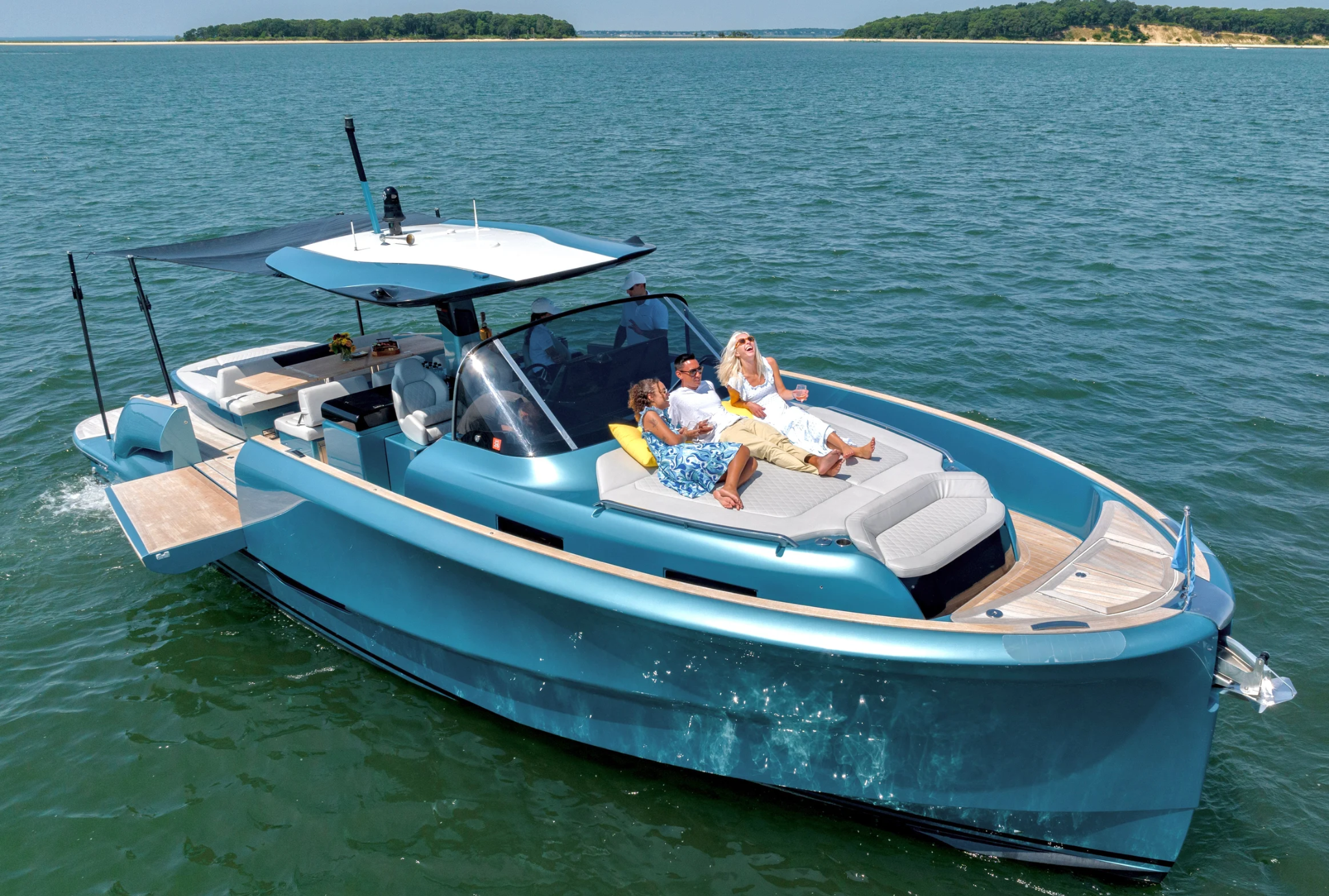 Modern motorboat cruising Intracoastal with passengers sunbathing onboard.