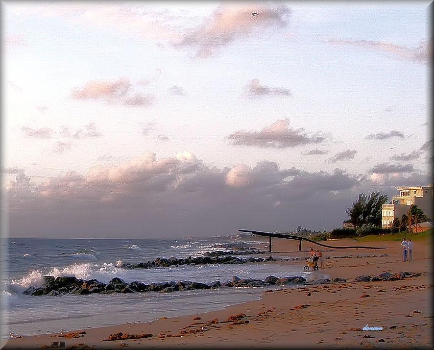Ocean Inlet Park beach with jetty, sunset, and walkers.