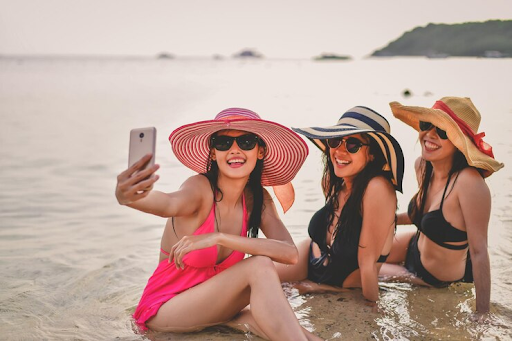 Bride and Bridesmaids clicking pictures on the beach