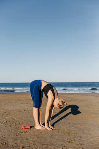 Women doing pre-activity stretch before kayaking.